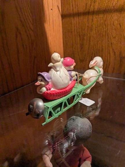 Celluloid windup w/ rabbit, 3 chicks, egg and basket w/ bell
