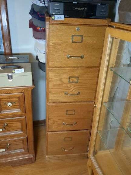 Filing cabinet, JVC 20" TV, Toshiba VHS player, VHS rewinder and International hats with stand