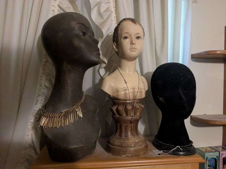 3 Manequin heads one with beaded necklace image