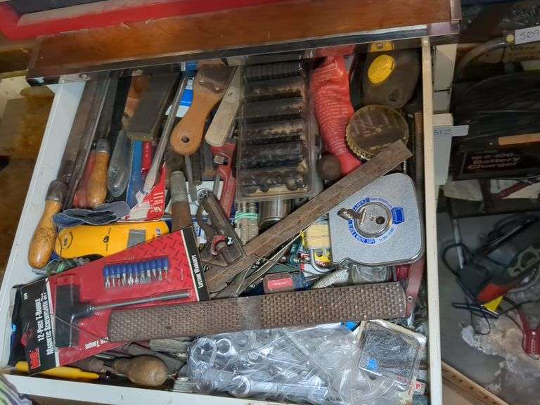 Cabinet (40" x 24" x 25")and top drawer: stud finder, tape measure, large metal file and misc on wall