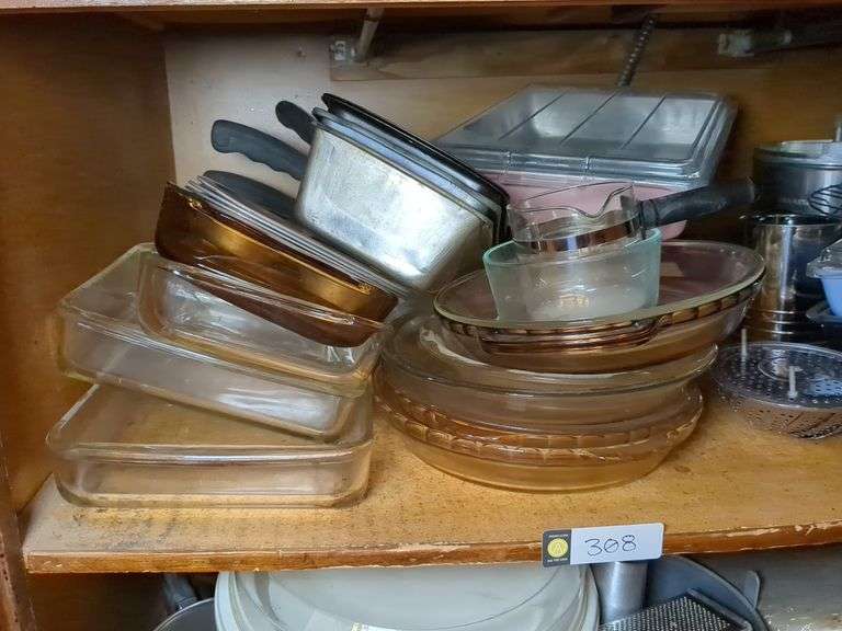 Top shelf: pie plates, baking dishes, sifter, bowls and misc.