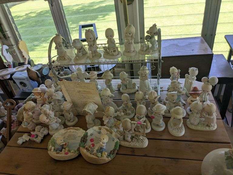 40+ precious moments figurines and misc figurines like Gobel figurines. Wall shelf image