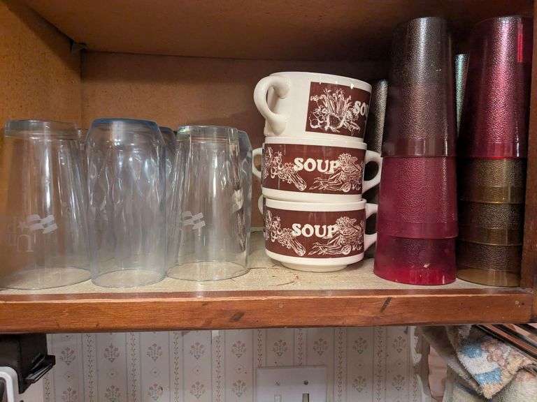 Bottom shelf: soup bowls, glasses and plastic cups image
