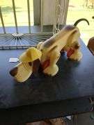 Windup dog plastic w/ yellow hat, wall shelf