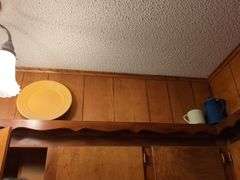 Decorative dishes and tins on top ledge