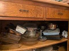 Top shelf: pie plates, baking dishes, sifter, bowls and misc.