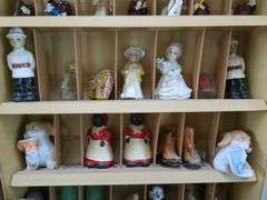 Winston curio cabinet with California Raisens, Mickey, and other misc figurines, cowboy boot salt/pepper shakers