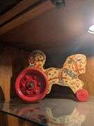 The Gongbell Mfg horse w/ dog and chariot pull toy