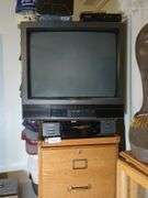 Filing cabinet, JVC 20" TV, Toshiba VHS player, VHS rewinder and International hats with stand