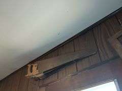 3 hand saws and 3 pieces of wall art