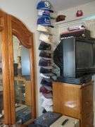 Filing cabinet, JVC 20" TV, Toshiba VHS player, VHS rewinder and International hats with stand