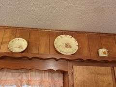 Decorative dishes and tins on top ledge