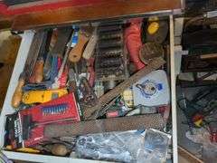 Cabinet (40" x 24" x 25")and top drawer: stud finder, tape measure, large metal file and misc on wall