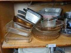 Top shelf: pie plates, baking dishes, sifter, bowls and misc.