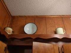 Decorative dishes and tins on top ledge