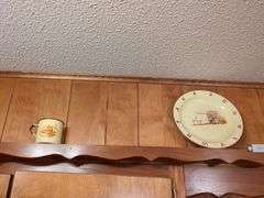 Decorative dishes and tins on top ledge
