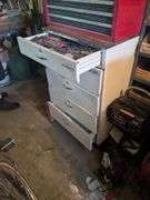 Cabinet (40" x 24" x 25")and top drawer: stud finder, tape measure, large metal file and misc on wall