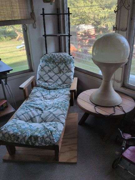 Wooden chaise lounge, wooden table and vintage tulip light image