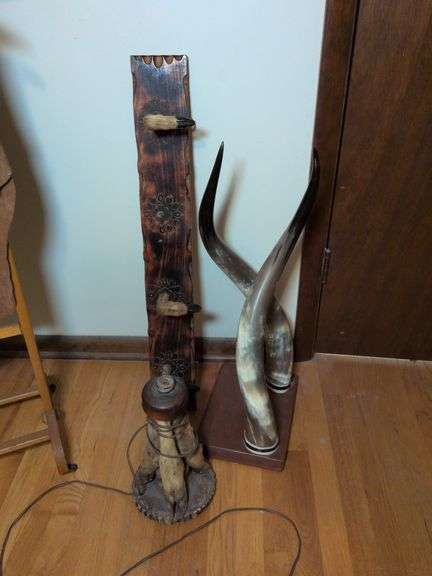 Taxidermy art: wall mounted horns, hoof rack and hoof lamp base image