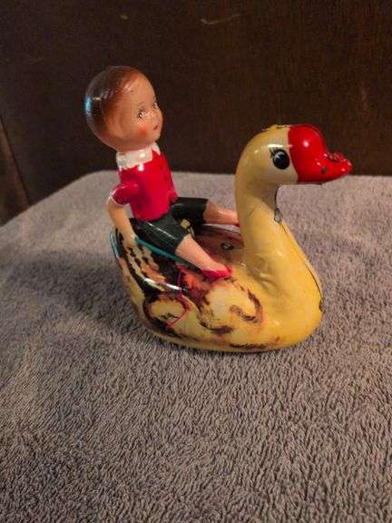 Vintage Wind-up with celluloid child riding tin goose image