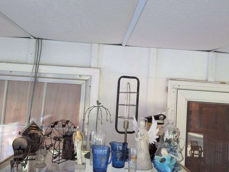 Decorative items: lamp, metal necklaces hanger, 2 Shirley Temple cups, Porcelain traffic officer, Guiness pint glass and misc. image