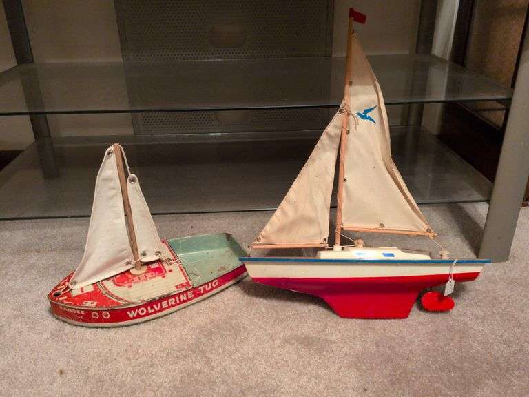 Vintage Wolverine Tug and toy sailboat image