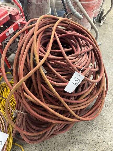 Bundle of Red Industrial Water Hoses