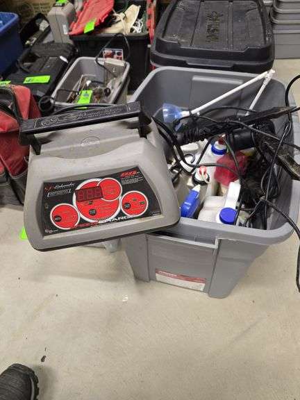 Tote with battery charger laser lights and lawn fertilizer image