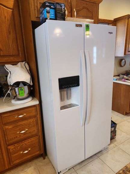 Whirlpool side by side refrigerator with ice maker and water dispenser image