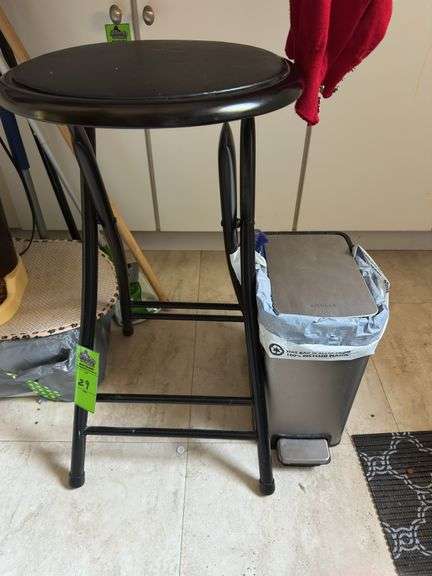 Black metal stool and garbage can
