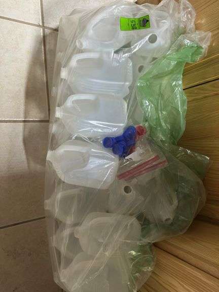 Unused milk sized plastic jugs with lids