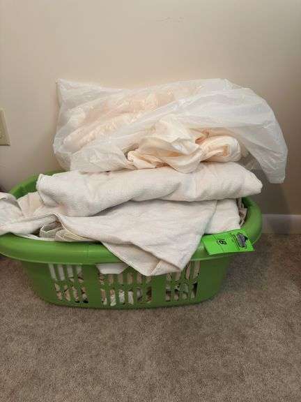 Laundry basket, full of miscellaneous sheets, and linens