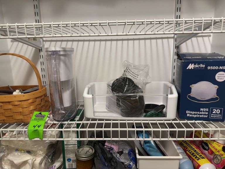Contents of shelf in closet, basket of silverware, Britta filter, disposable masks