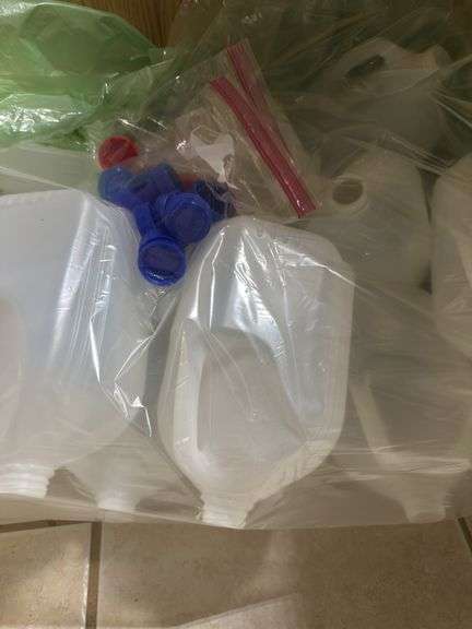 Unused milk sized plastic jugs with lids