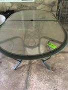 Oval glass top table with umbrella stand