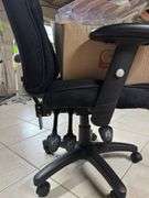Black office chair with box of office supplies