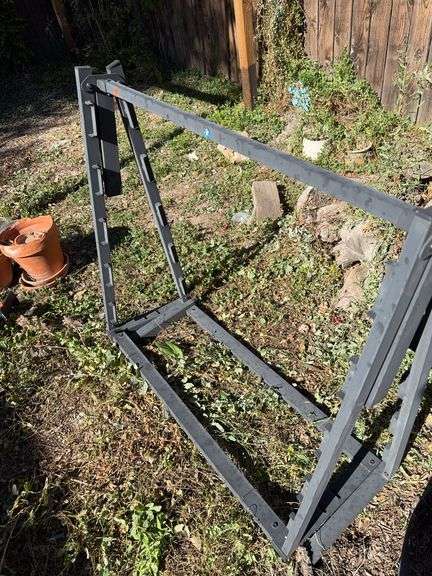 Twin bed frame and pile of fire wood image