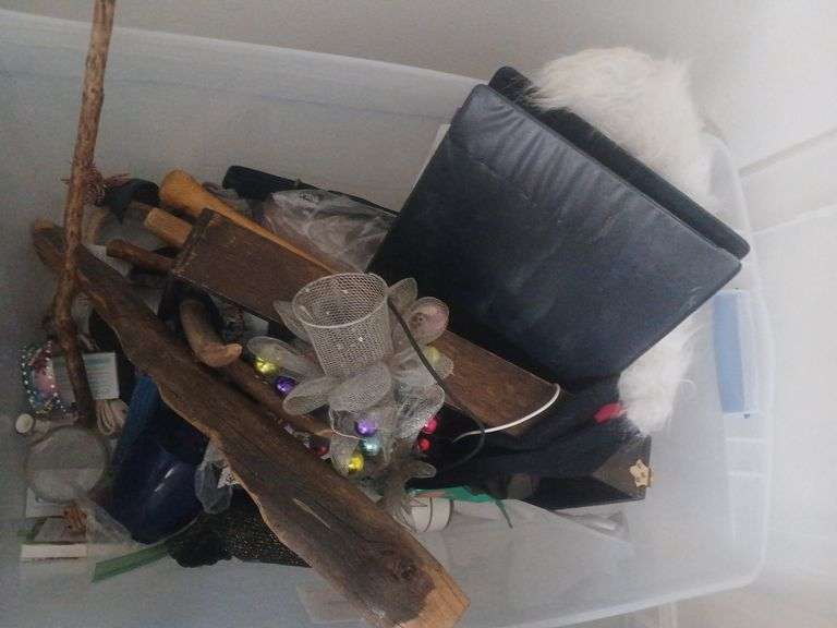 Bin with wooden decorations/sticks vase and other random decorations. image