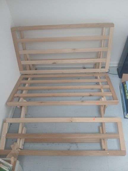 Wooden futon with mattress and mattress cover. image