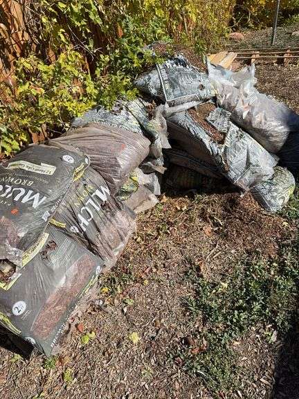 Pile of bags of mulch.  You load image
