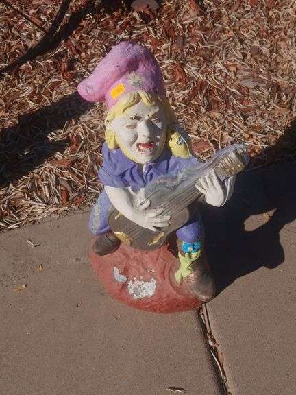 Gnome playing a guitar stone yard decoration image