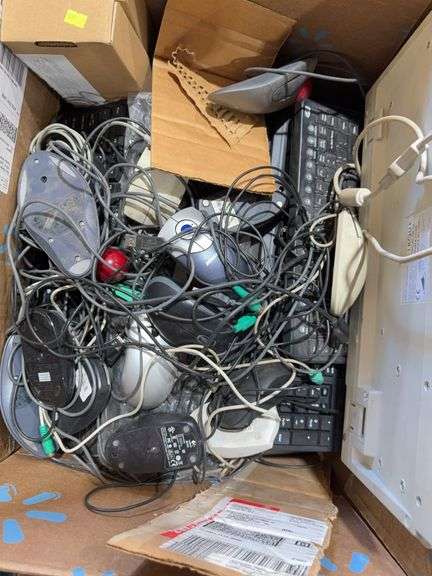 Box of keyboards and corded mice for computers image
