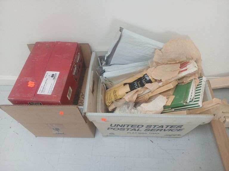 Box of jars and a bin with candles paint and shipping envelopes image