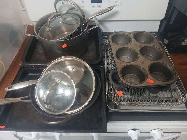 Lot of pots and pans with cooking racks . image
