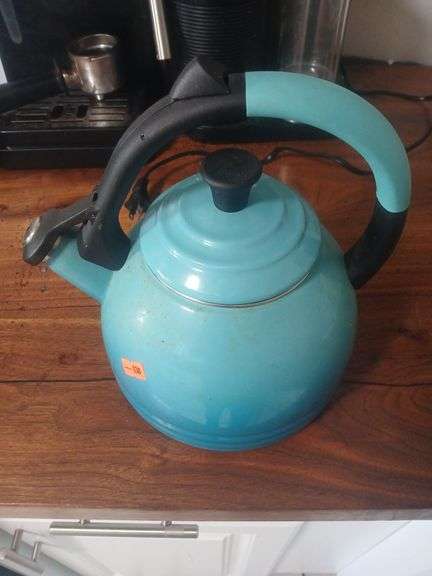 Blue metal kettle. Le creuset. image