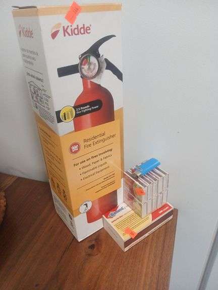 Kidde fire extinguisher with matches and a lighter. image