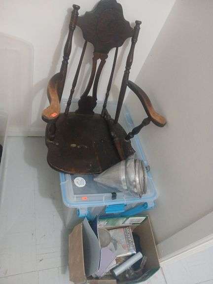Bin with wheels broken wooden chair and box of books and arts stuff. image