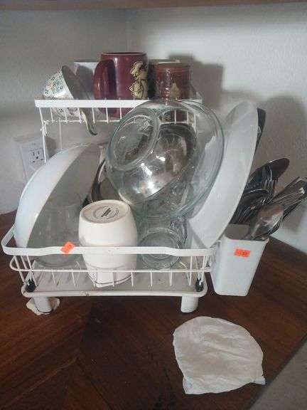 Kitchen supplies cups, plates, silverware with strainer. image