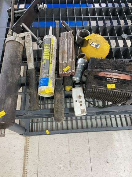 Bundle of miscellaneous tools. Power inverter, grease gun and hand tools. image