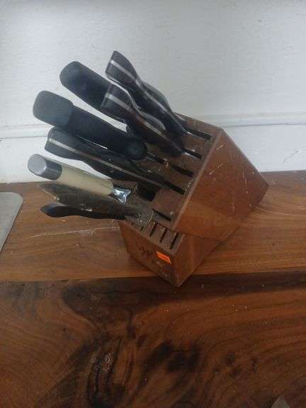 Wooden knife holder with knifes. image